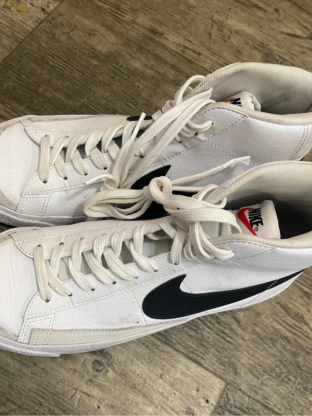 Nike White High-Top Sneakers with Black Swoosh